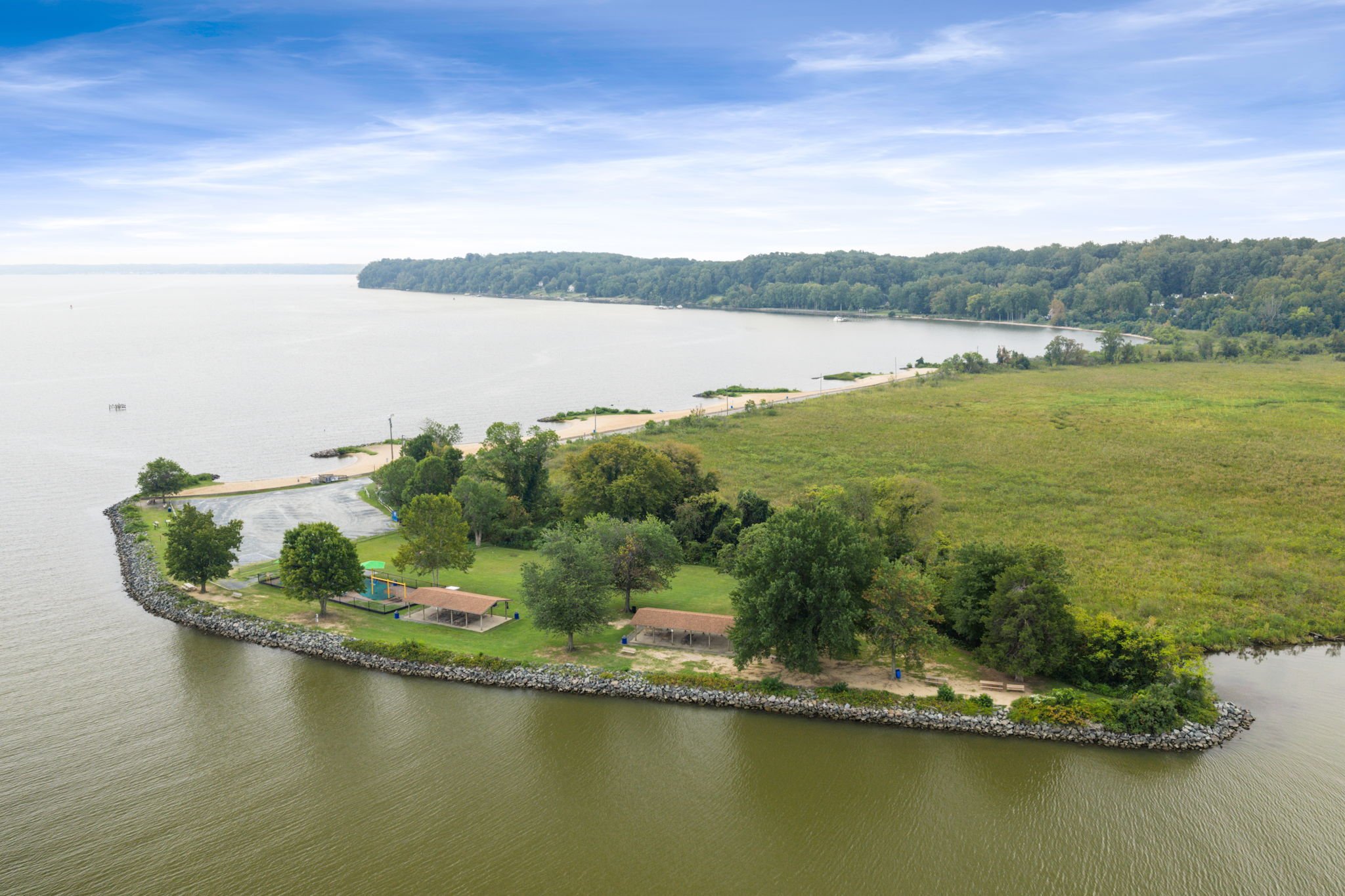 Aerial view of a sandy shoreline path along the water