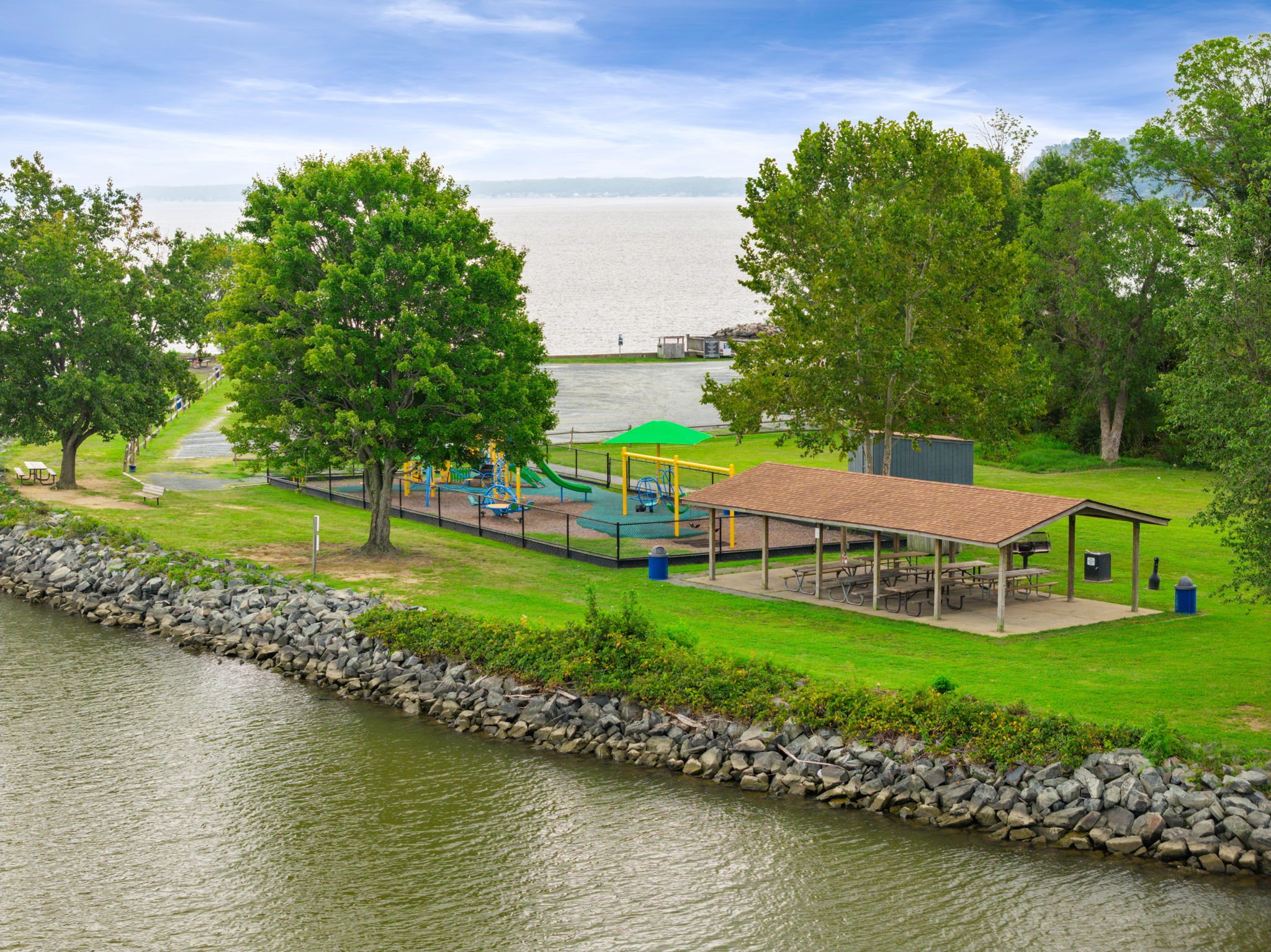 Waterfront playground with shade sails overlooking the water