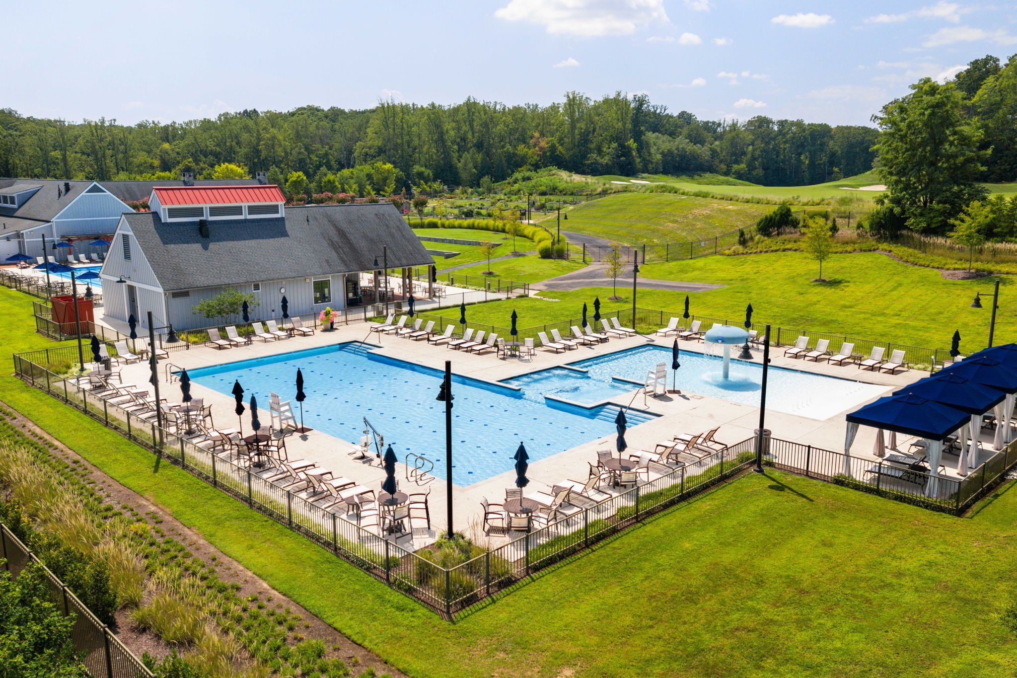 Community lap pool with lounge chairs and clubhouse