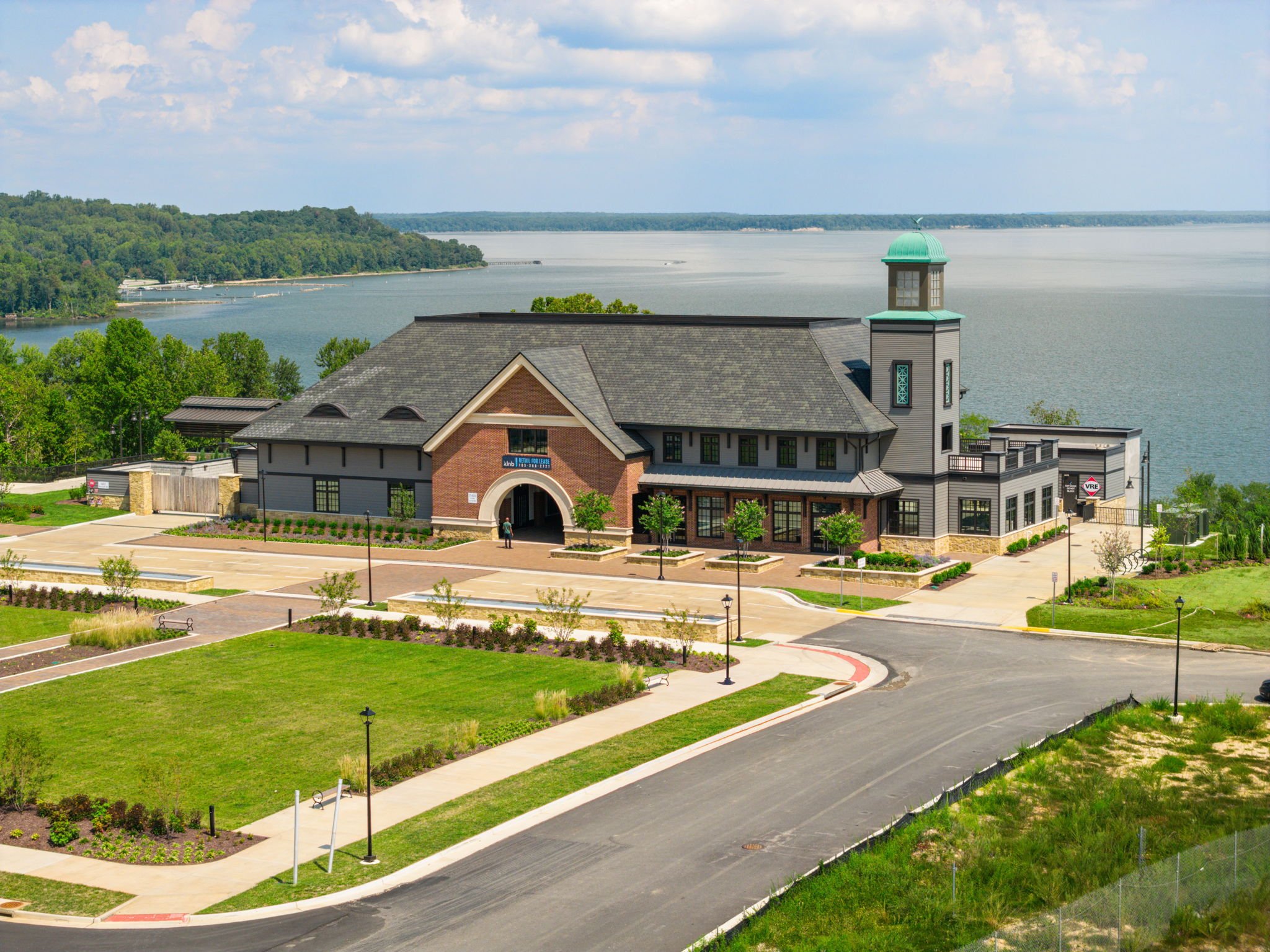 Waterfront brick clubhouse with lighthouse-style tower overlooking the river