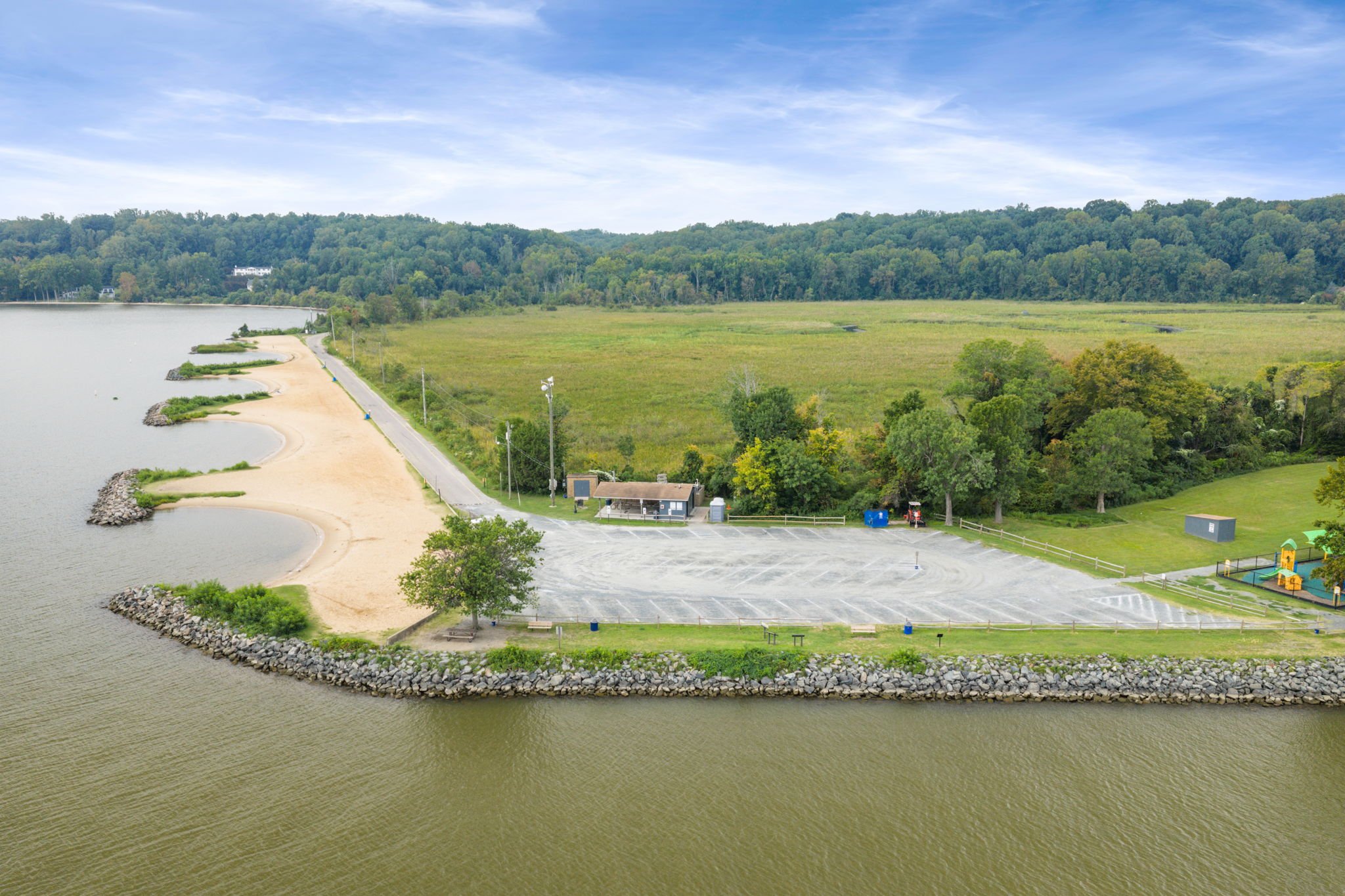 Aerial view of a waterfront park with pavilions and playground