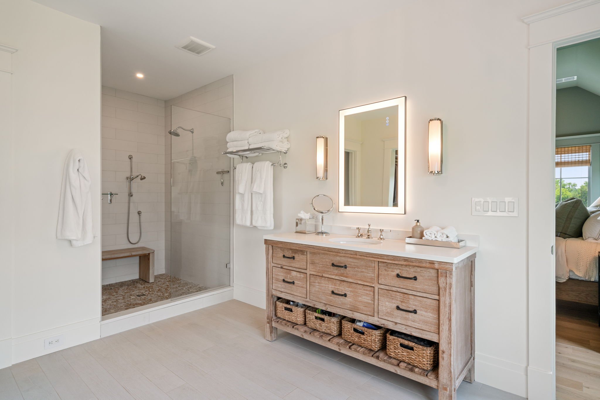Walk-in shower with glass door and wall-mounted towel rack