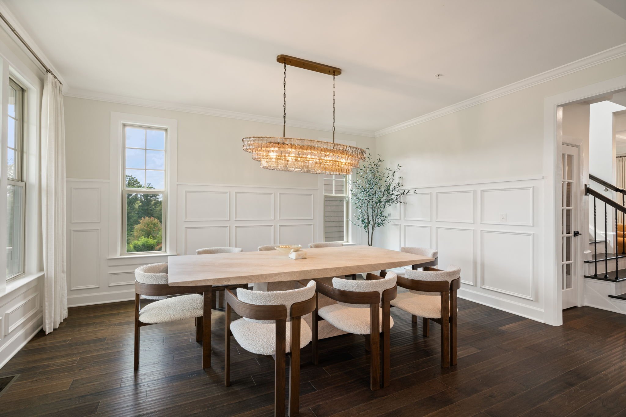 Formal dining room, alternate angle, with chandelier and large windows