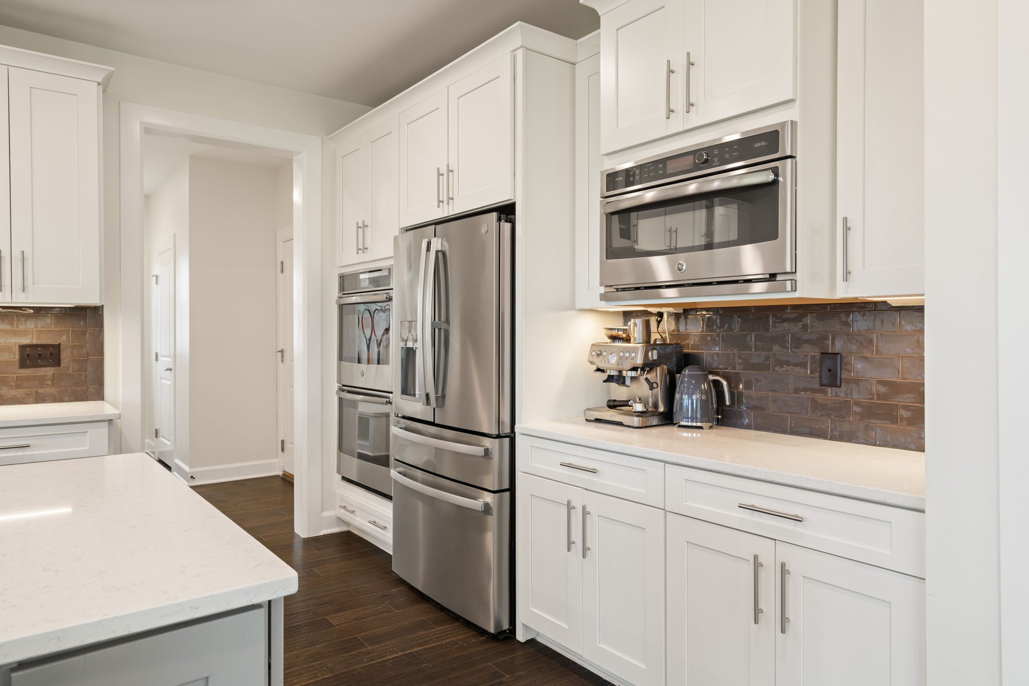 Kitchen detail with refrigerator and wall oven