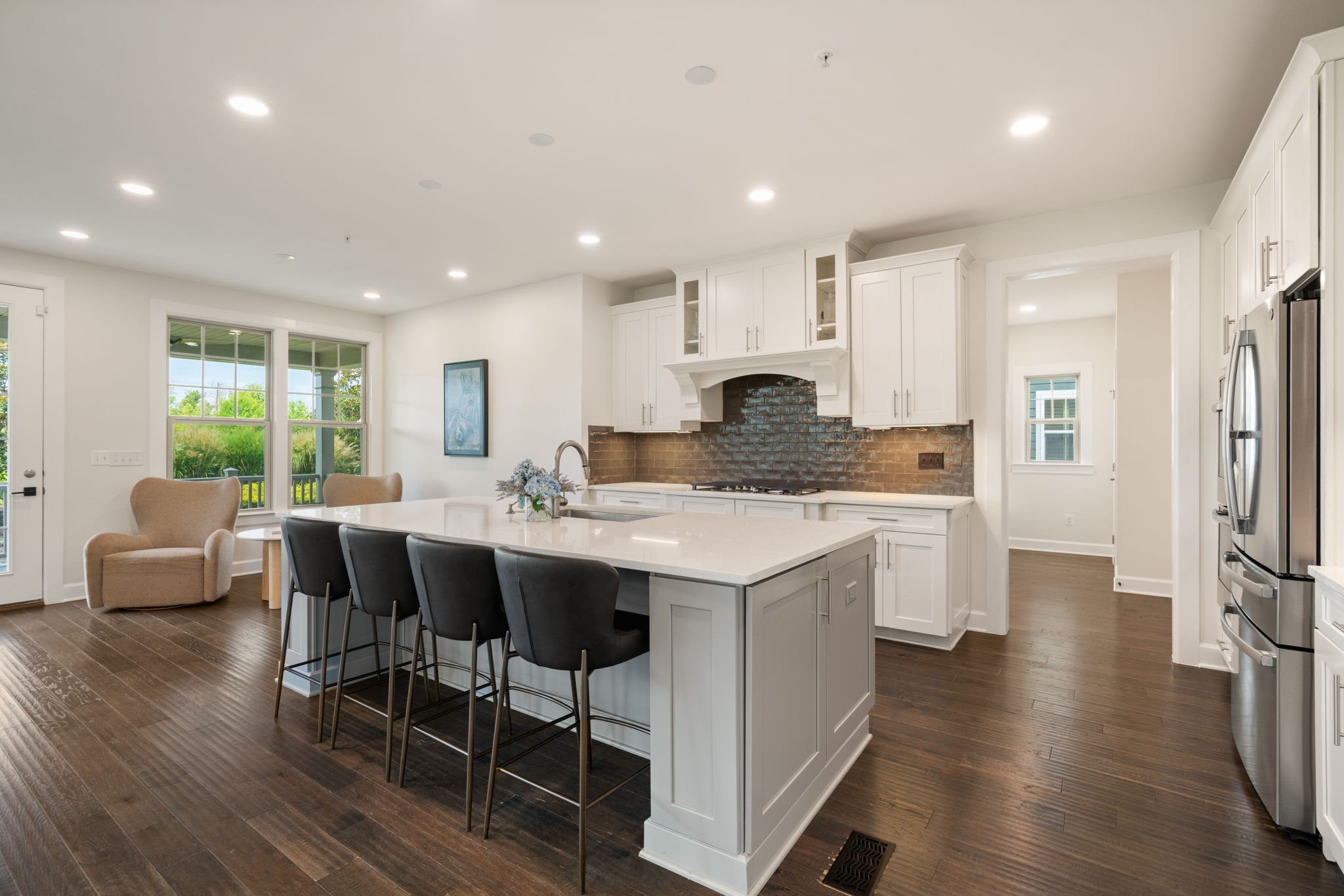 White kitchen with center island open to the living area