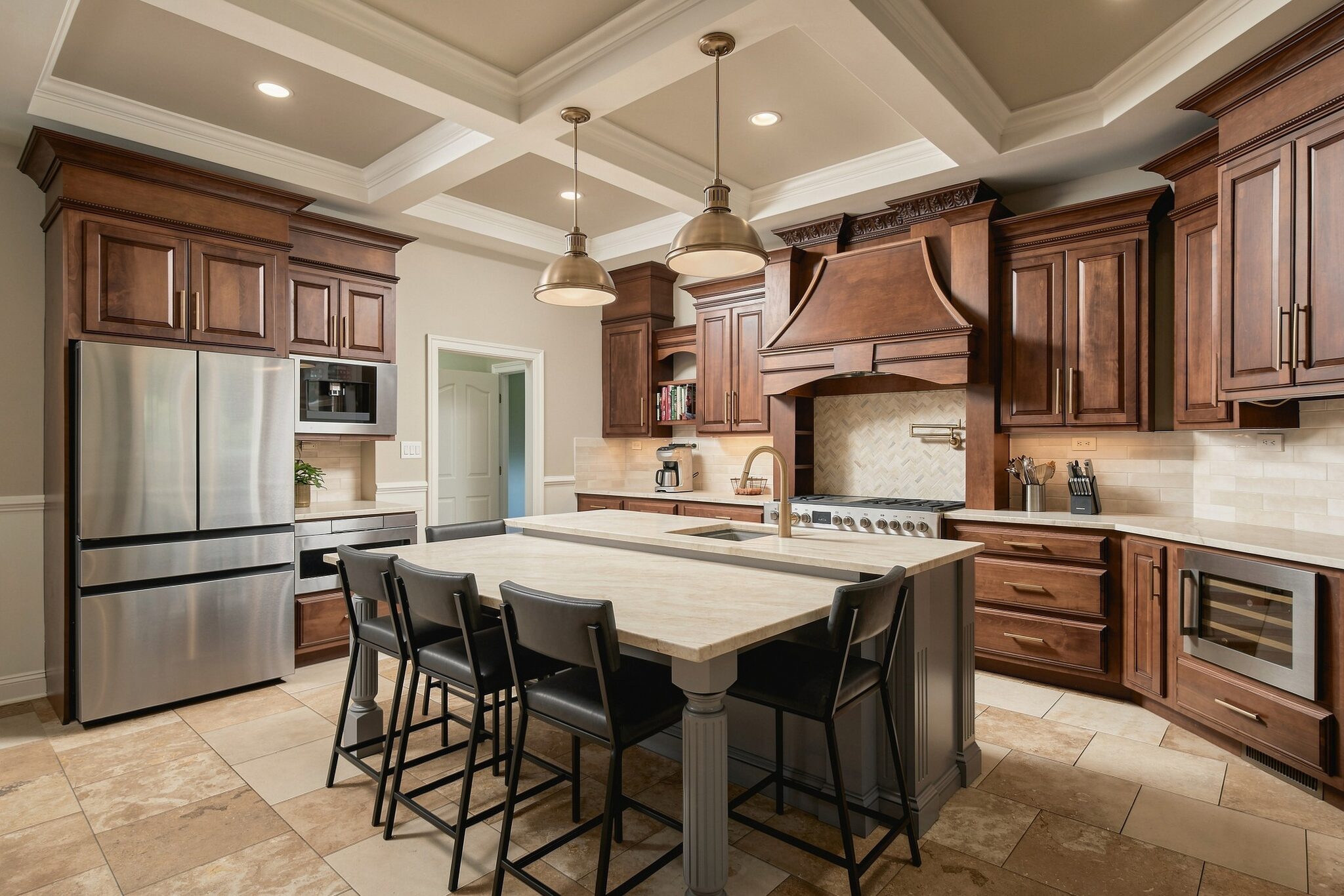 Gourmet range with brass pot filler and herringbone tile backsplash