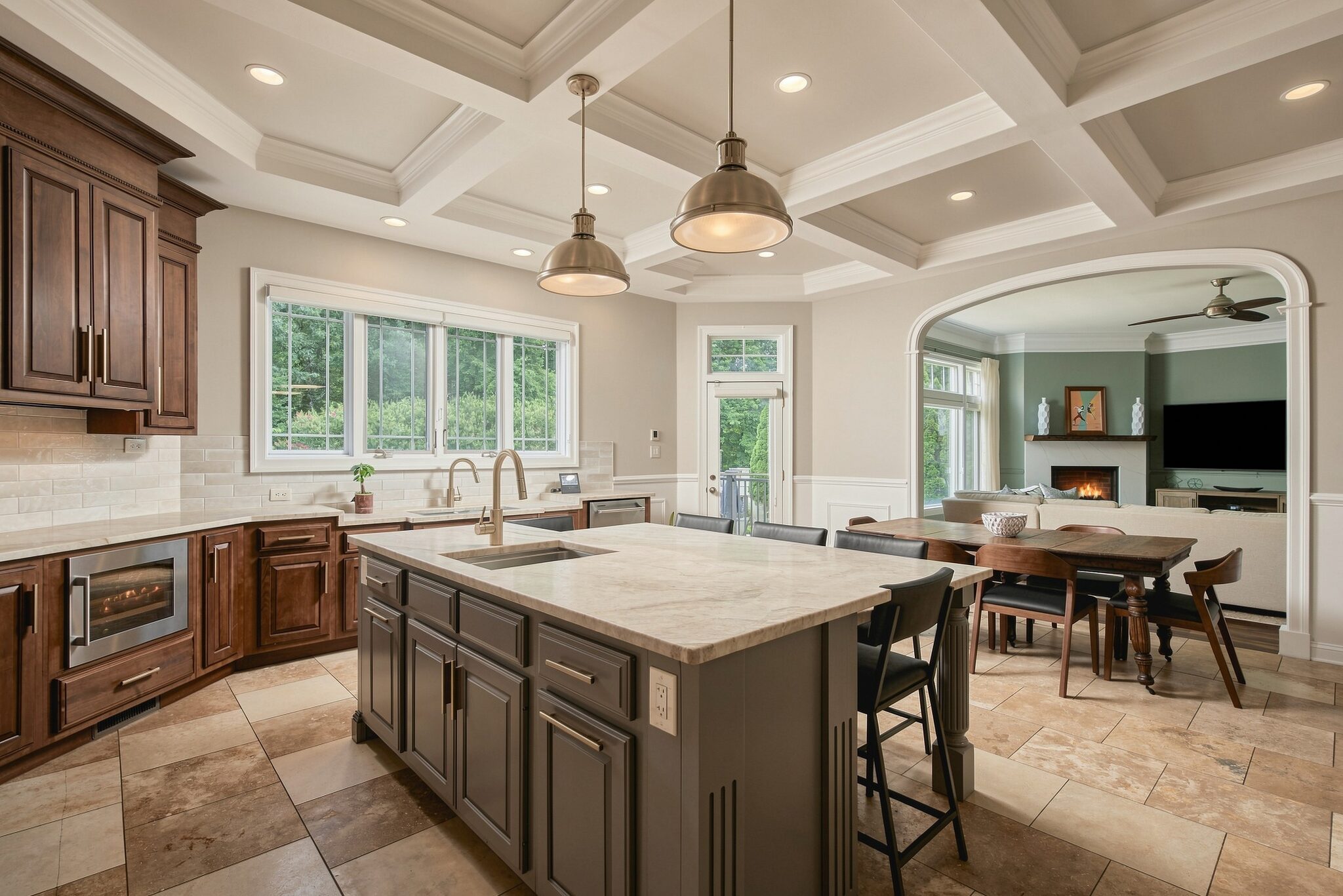 Built-in refrigerator and microwave alcove framed by rich wood cabinetry